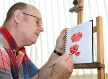 FINE DETAIL: Artist Malcolm MacDonald at work on the poppy painting for the front cover of a book of children's war poems. Picture:RICHARD DOUGHTY (11860787)
