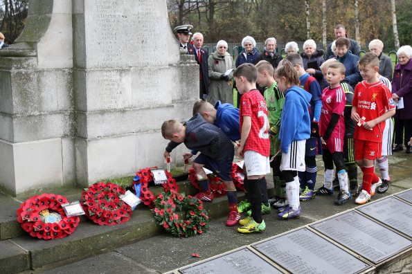 YOUNG AND OLD: Players from South Park Rangers place crosses on the war memorial at Smith’s Dock Park, Normanby. Picture: TOM BANKS