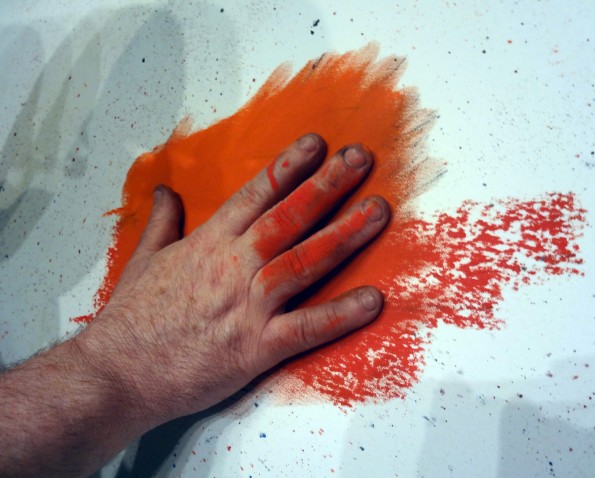 SHOWING HIS HAND: Mackenzie Thorpe reveals his technique during the creation of the poppy artwork
