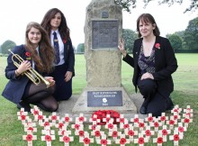 HEROES REMEMBERED: (L-R) Ripon Grammar School pupils Martha Barber and Shannon Millar with Old Riponian Claire Green at the First World War commemorative stone with poppies bearing the names of all those former pupils and masters who were lost.