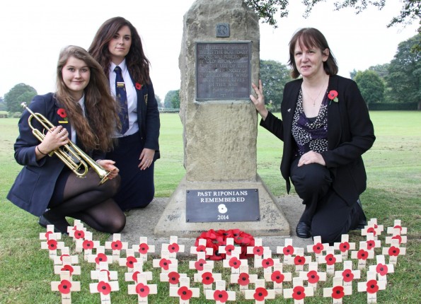 HEROES REMEMBERED: (L-R) Ripon Grammar School pupils Martha Barber and Shannon Millar with Old Riponian Claire Green at the First World War commemorative stone with poppies bearing the names of all those former pupils and masters who were lost.