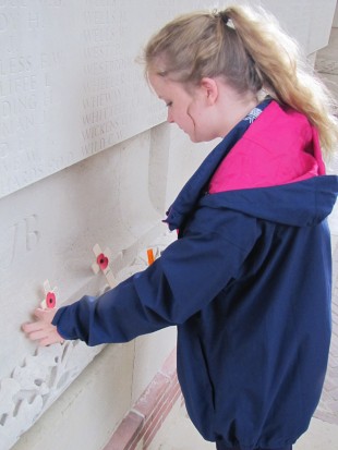  Paying respects: Student Kirsty Bagley places a cross at the Thievpal Memorial in memory of the missing.