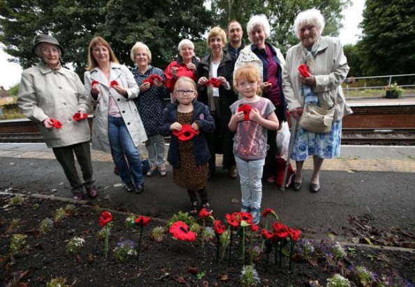 A team of knitters have begun making thousands of poppies to be ready for Armistice Day. They are pictured at Nunthorpe Railway Station in Middlesbrough, fronted by Sophie Marshall (6) and Iris McGlynn (5). Picture: CHRIS BOOTH