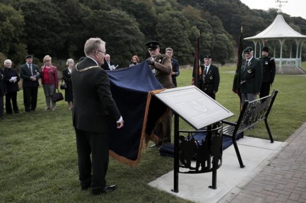 SECOND BENCH: Cllr Edward Bell and Colonel James Ramsbotham unveil the Durham Pals memorial bench, with the bandstand in the background, on the Racecourse yesterday. Picture by Stuart Boulton