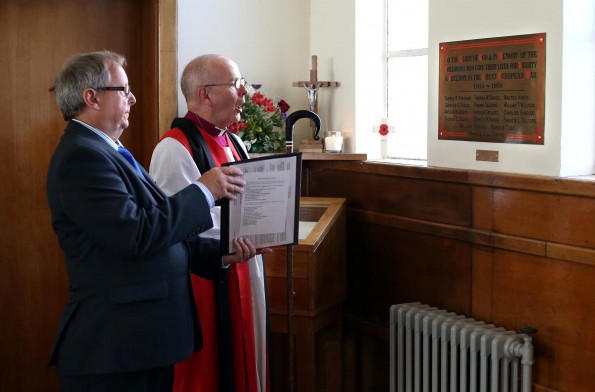 Bishop of Jarrow, Rt Revd Mark Bryant re-dedicates the plaque.  Alongside him is server Peter Hakin.  Picture: CHRIS BOOTH