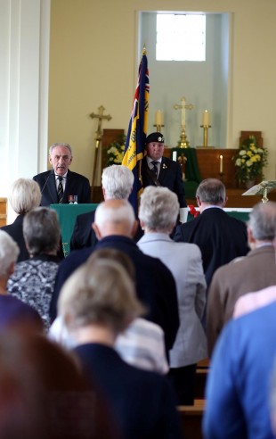Ron Fairhurst of the British Legion addresses the congregation with standard bearer Andrew Flynn.  Picture: CHRIS BOOTH