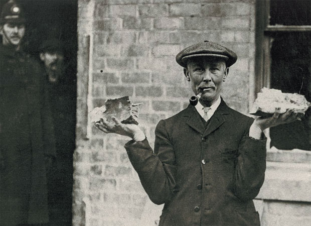A man holds up fragments of German shell in Hartlepool - such fragments were very soon afterwards being sold a souvenirs